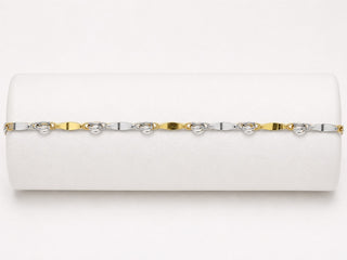 White clutch with gold and silver chain strap on a white background